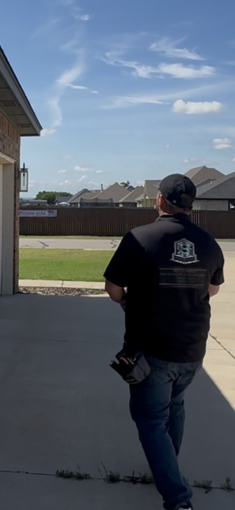 Commercial property inspector in a black shirt surveying a property in Oklahoma City