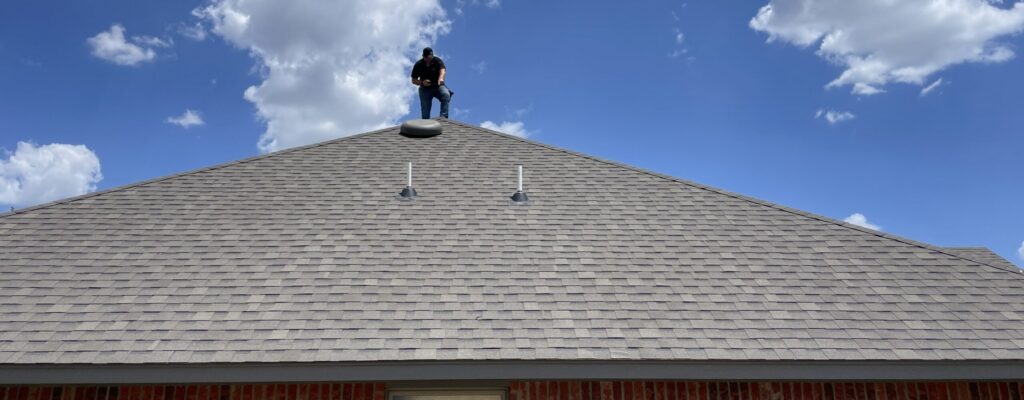Oklahoma City home inspector Travis Haberman inspecting a roof